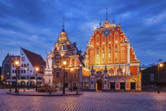 Riga Town Hall Square, House of the Blackheads and St. Roland Statue illuminated in the evening