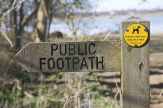 Arrow direction pointer on wooden public footpath sign, Sutton, Suffolk, England, United Kingdom,