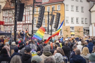 People on a town square during a demonstration with rainbow flags, demonstration against the right,