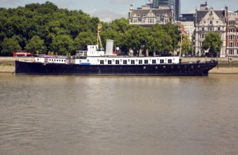 Looking across the River Thames to HMS President on the Embankment, London