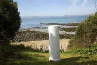 White marker post by sandy beach, Island of Herm, Channel Islands, Great Britain