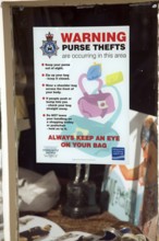 Police notice warning of purse thefts in shop window Britain