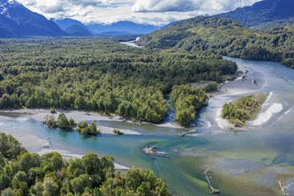 Aerial view over confluence of rivers Rio Frio and Rio Yelcho, dead tree trunks on sandbanks,