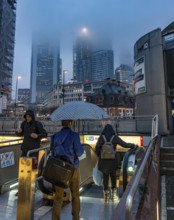 Rainy weather, freezing rain, entrance to Hauptwache underground station, high-rise skyline in