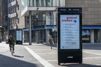 Advertising displays, give advice on correct behaviour, empty city centre, shopping street,