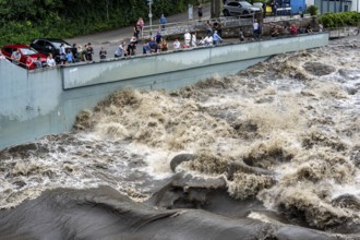 Weir of the Lake Baldeney in Essen, the masses of water roar through the open weirs, spectators,