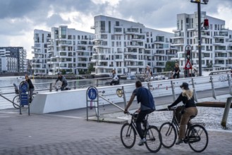 Cyclists on the Bryggebroen cycle and footpath bridge over the harbour, Sydhavnen, Copenhagen is