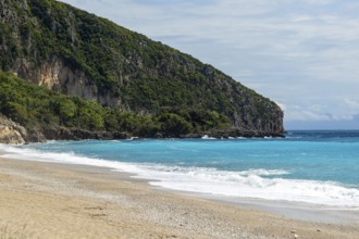 Coastal landscape of blue turquoise water of Ionian Sea, rocky headland and beach, Dhermi, Albania,