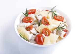 Chicken fillet salad with rosemary, pineapple and cherry tomatoes isolated on white background.