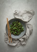 Fried bean pods, in soy sauce, with sesame seeds, homemade, no people