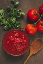 Tomatoes in their own juice, sliced, tomato sauce, tomatoes, in a cup, top view, close-up, no