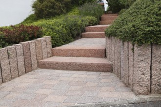 Well-kept front garden with block steps, ornamental stones and planting