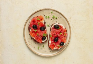 Sandwiches with red fish, cream cheese, olives and microgreens, breakfast