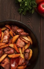 Ojakhuri, Traditional Georgian dish, fried potatoes with meat, in a clay frying pan, top view, no