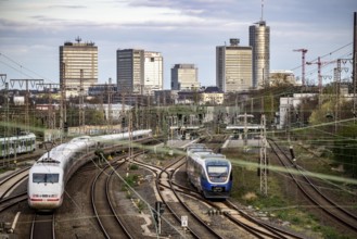 Train on the tracks west of Essen central station, skyline of the city centre, ICE train, North