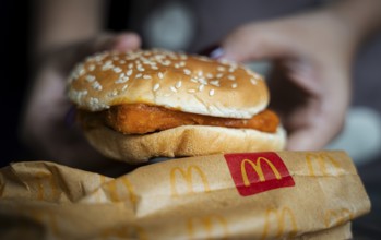 A woman shows a McDonald's burger on October 26, 2024 in Guwahati, India. McDonald's recent food