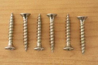 Phillips screws on wooden background, wood screws, spax screws