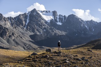 Hiker in a mountain valley in the Tien Shan Mountains, near Altyn Arashan, Kyrgyzstan, Asia