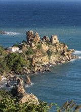 Ruins of Torre Caldura Castle on a rocky promontory jutting into the sea near Cefalu, Sicily,