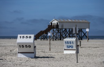 Beach chairs and signs on the sandy beach of the North Sea, Sankt Peter-Ording, Schleswig-Holstein,