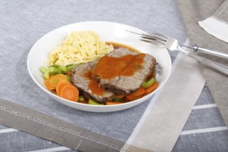 Swabian cuisine, roast beef, roast ox, herb spaetzle, meat dish, gravy, carrot vegetables, leek,