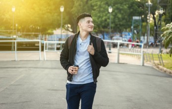 Smiling guy walking down the street. Urban handsome man walking down the street