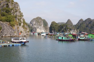 The floating fishing village of Cai Beo and the karst rocks in Lan Ha Bay, Halong Bay, Vietnam,