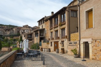 A rustic restaurant in a historic old town with a cosy atmosphere and vines, Alquézar, Alquezar,