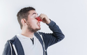 Person with nosebleed isolated. Concept of nasal congestion