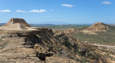 Vast landscape with a plateau and hills under a clear blue sky, Bardenas Reales Natural Park,