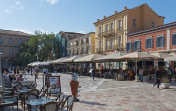 Busy square with cafés and parasols, surrounded by Mediterranean buildings, Syntagma Square,