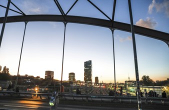 Chilling out at sunset on the Modersohn Bridge, view of railway tracks, trains and the 140 metre