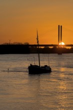 Sunset over river Rhine Lower Rhine, on the left in the foreground anchored historical ship