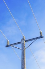 Power line with hoarfrost a cold winter against a clear blue sky, Sweden, Europe