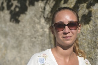 Portrait of a young woman with sunglasses in summer