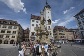 Tourists at the four-tube fountain, baroque fountain of the 18th century, behind the town hall,