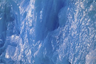 Ice wall in turquoise color with sun reflections on a glacier in arctic, Spitsbergen, Svalbard,