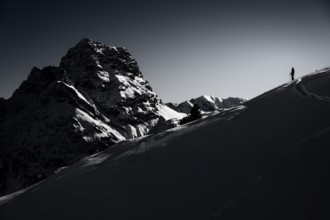 Mountaineers in front of the summit of the Großer Widderstein in winter, Baad, Vorarlberg, Austria,