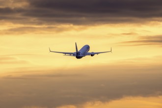 Passenger aircraft in front of a cloudy morning sky, sunrise, SunnExpress, Baden-Württemberg,