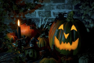 Illuminated pumpkin with spiders and candle in a mystical Halloween scene