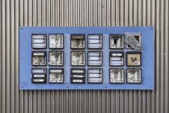 Doorbell sign, broken letterbox system on a dilapidated block of flats in Stuttgart,