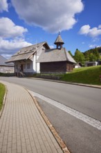 Chapel Unterlehen with road under blue sky with cumulus clouds in Bernau im Black Forest, Black