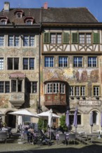 Imposing, historic half-timbered buildings with detailed facade paintings on the market square in