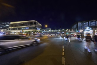 Zoologischer Garten railway station, Primark shop, vehicles and pedestrians with motion blur at