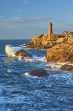 Lighthouse, Phare de Mean Ruz or Phare de Ploumanach, in the foreground rocky coastal landscape,