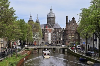 View from a bridge at the Oudezijds Voorburgwal onto the canal and the Sint Nicolaaskerk, St