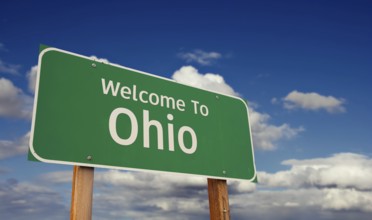 Welcome to ohio green road sign over blue sky with some clouds