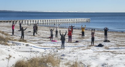 Group of exercisers in winter on the beach in Ystad, Skåne County, Sweden, Baltic Sea, Scandinavia,