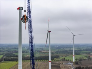 Assembly of an Enercon E-138 wind turbine, the stator, part of the generator is pulled to the