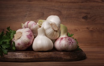 Fresh young garlic, white and purple color, on a wooden table, no people